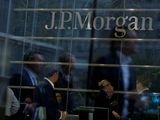 Trabajadores se reflejan en vidrieras de las oficinas de JP Morgan en Canary Wharf en Londres. Foto de archivo Sep19, 2013. REUTERS/Neil Hall/File Photo