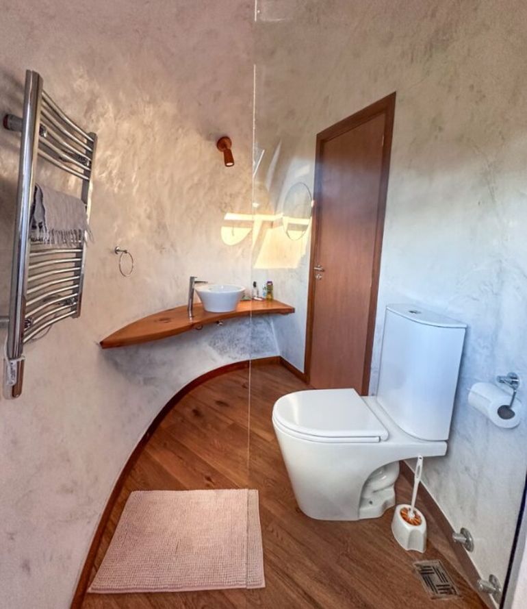 Las curvas del baño: todo el mobiliario fue diseñado a medida y especialmente para que se adapte al alojamiento con forma de huevo. Las curvas del baño: todo el mobiliario fue diseñado a medida y especialmente para que se adapte al alojamiento con forma de huevo. 