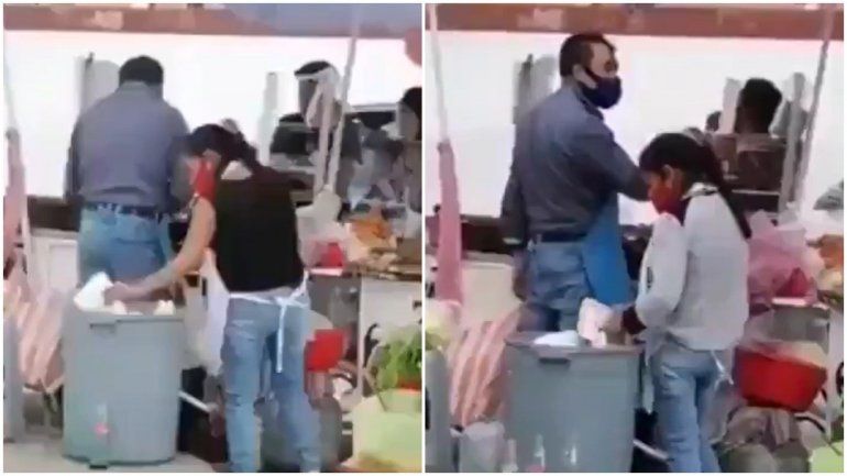 Graban a mujer mientras saca platos de la basura para rehusarlos en su puesto de comida