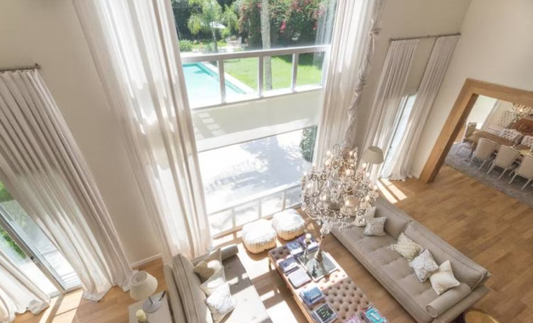 El living principal tiene doble altura y está rodeado por dos enormes escaleras enfrentadas.