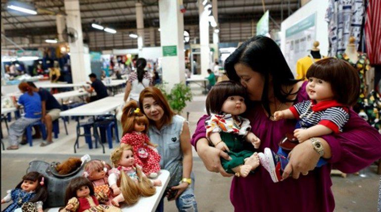 Una mujer tailandesa con sus muñecas espirituales