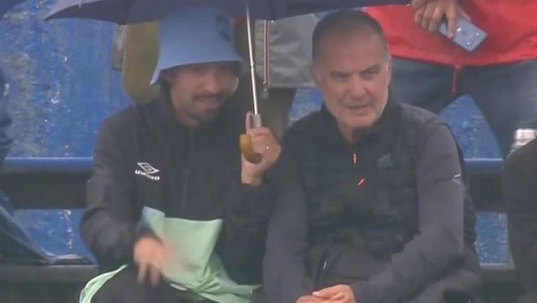 El fanático cubrió a Marcelo Bielsa de la lluvia.