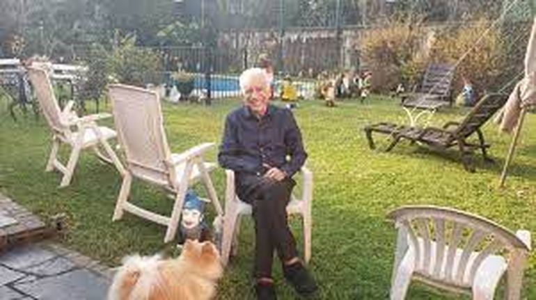 Alberto disfruta el jardín de su casa junto a su perro.