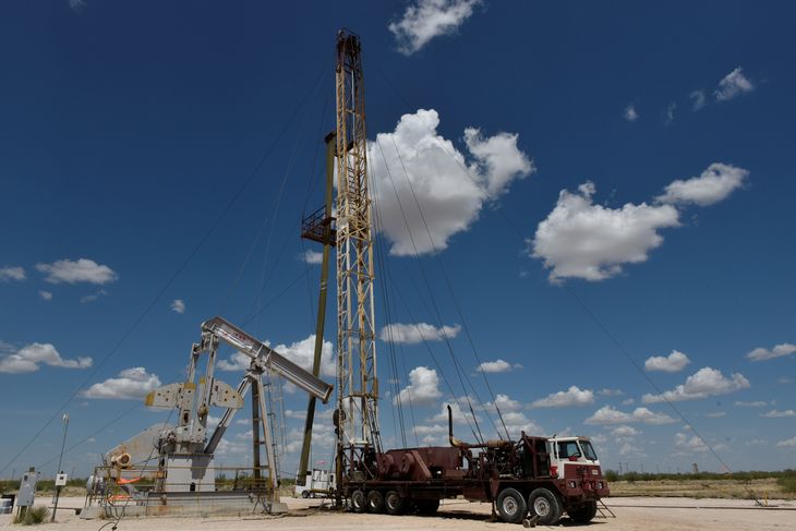 FILE PHOTO: A work-over rig performs maintenance on an oil well in the Permian Basin oil production area near Wink, Texas U.S. August 22, 2018. Picture taken August 22, 2018. REUTERS/Nick Oxford/File