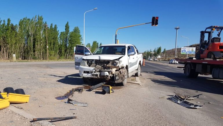 Mala maniobra ocasionó un fuerte choque: una mujer herida y un semáforo tirado
